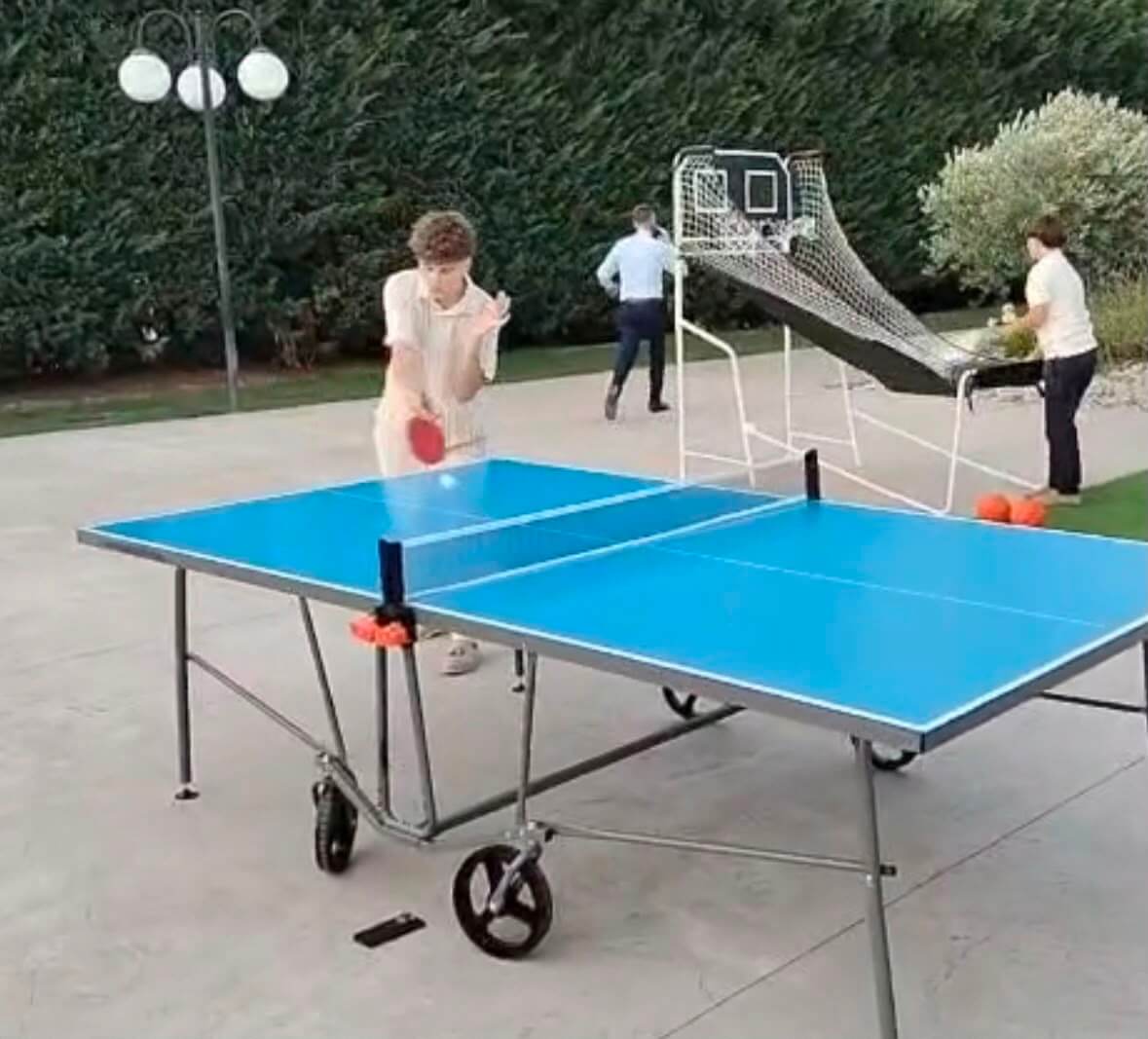 Invitați jucând tenis de masă în aer liber